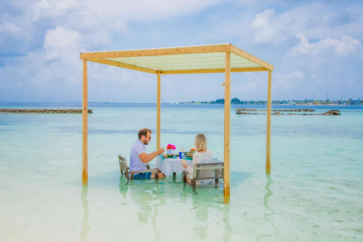 Couple enjoying lunch in ocean at Kagi Maldives unique honeymoon destination